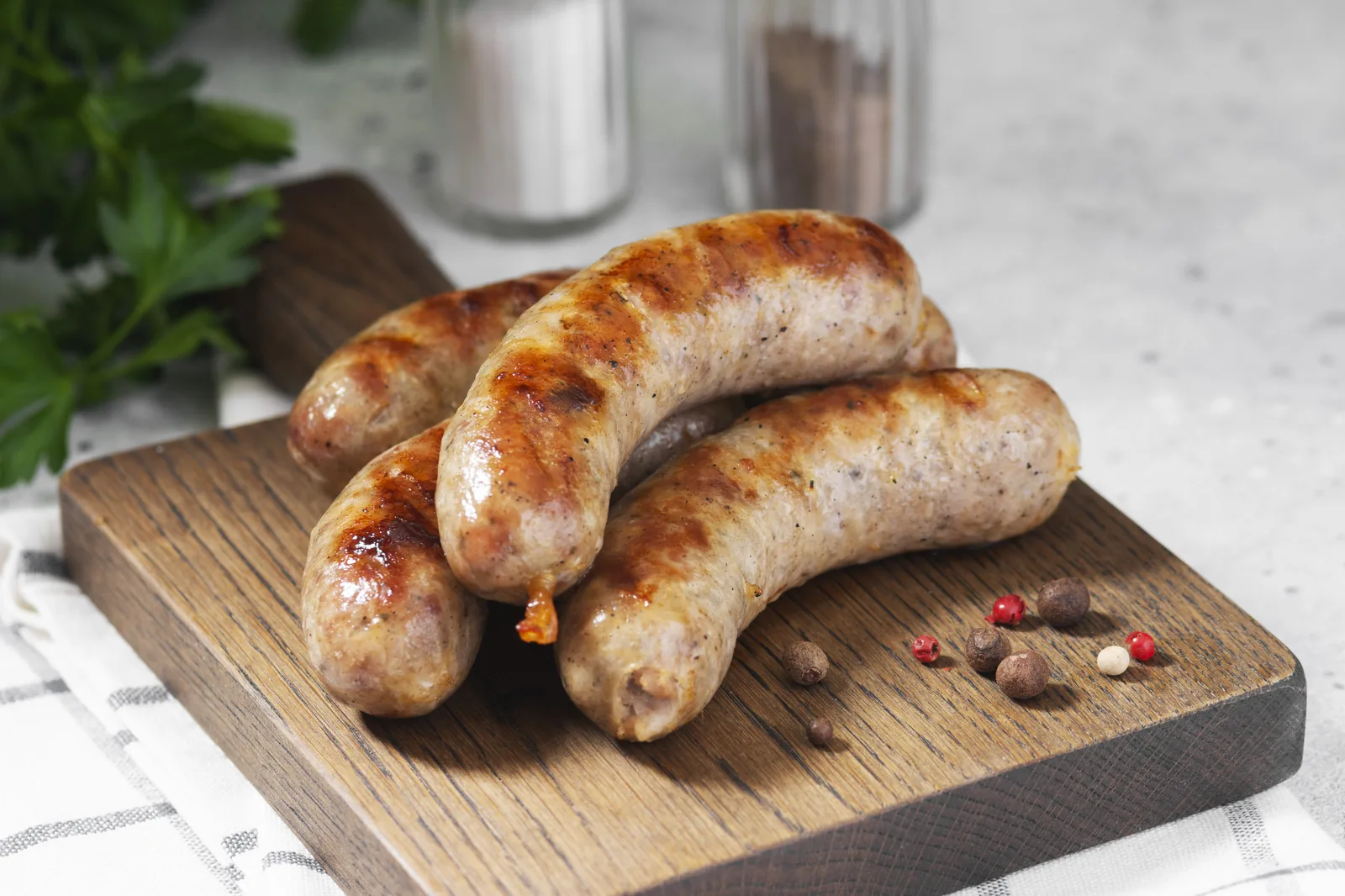 Grilled sausages arranged on a wooden board